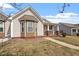 Charming single story home features covered porch with chairs, manicured lawn, and well-maintained landscape at 75 E Moss Creek Dr, Clayton, NC 27520