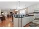 Open kitchen flows into living area with white cabinets and black countertops at 75 E Moss Creek Dr, Clayton, NC 27520