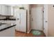Functional kitchen featuring white appliances, granite counters, and hardwood flooring at 75 E Moss Creek Dr, Clayton, NC 27520