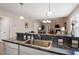 Kitchen area view showcases granite countertops, stainless steel sink, open layout, and seamless entertaining space at 75 E Moss Creek Dr, Clayton, NC 27520