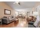 Open concept living space with hardwood floors, sofa, and dining area, great for entertaining at 75 E Moss Creek Dr, Clayton, NC 27520