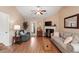 Bright and airy living room with hardwood floors, fireplace, and views into the dining area at 75 E Moss Creek Dr, Clayton, NC 27520