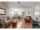Inviting living room featuring hardwood floors, a comfortable sofa, and an open floor plan flowing into the dining area at 75 E Moss Creek Dr, Clayton, NC 27520