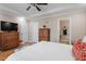 A spacious main bedroom features hardwood floors, tray ceilings, and wood furniture at 75 E Moss Creek Dr, Clayton, NC 27520