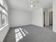 Charming bedroom with a ceiling fan, plush carpeting, and a bright window providing natural light at 7818 Spungold St, Raleigh, NC 27617