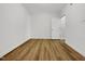 Bright bedroom with wood-look flooring and white walls, creating a modern, clean aesthetic at 7818 Spungold St, Raleigh, NC 27617