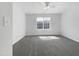 A light filled bedroom featuring neutral walls and gray carpeting at 7818 Spungold St, Raleigh, NC 27617