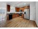 An eat-in kitchen with stainless steel appliances and wood cabinets at 7818 Spungold St, Raleigh, NC 27617