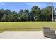 A well-manicured backyard featuring a patio and lawn, offering a serene outdoor space with natural views at 8710 Kenridge Ln, Fuquay Varina, NC 27526