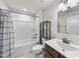 Clean bathroom with a tub/shower combo and dark wood cabinets, perfect for guests at 8710 Kenridge Ln, Fuquay Varina, NC 27526