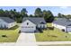 Charming single-story home with a well-manicured lawn and two-car garage at 8710 Kenridge Ln, Fuquay Varina, NC 27526