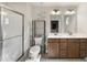 Bright main bathroom with double sink vanity, wood cabinets, modern fixtures and glass-enclosed shower at 8710 Kenridge Ln, Fuquay Varina, NC 27526
