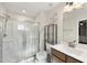 Bright bathroom with glass-enclosed shower and modern fixtures, vanity sink and open shelving at 8710 Kenridge Ln, Fuquay Varina, NC 27526