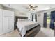 This main bedroom features a ceiling fan, gray walls and carpet, and a large window to let in plenty of light at 8710 Kenridge Ln, Fuquay Varina, NC 27526