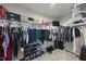 Organized walk-in closet with clothes hanging on rods and shoes on a rack, providing ample storage space at 8710 Kenridge Ln, Fuquay Varina, NC 27526
