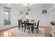 Bright dining area with a large window, a dark wood table, and seating for six at 921 Alden Bridge Dr, Cary, NC 27519