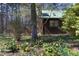 Home exterior showing a well-maintained yard with spring flowers at 9511 Collins Creek Dr, Chapel Hill, NC 27516