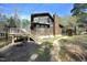 Exterior of the two-story home with wood siding, a chimney, and a deck at 9511 Collins Creek Dr, Chapel Hill, NC 27516