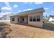 Back view of a single-Gathering home featuring a covered patio and a spacious, grassy yard at 96 Foxtail Ct, Clayton, NC 27520