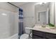 A well-lit bathroom with a shower, vanity, and decorative shower curtain at 96 Foxtail Ct, Clayton, NC 27520