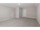 A spacious carpeted bedroom with multiple doors and a bright ceiling light at 96 Foxtail Ct, Clayton, NC 27520