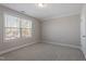Neutral carpeted bedroom features a large window providing plenty of natural light at 96 Foxtail Ct, Clayton, NC 27520