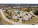 Aerial view of a community pool and pool house with ample parking surrounded by residences and greenery at 96 Foxtail Ct, Clayton, NC 27520
