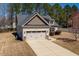 Charming home with a two-car garage, stone accents, and well-maintained lawn at 96 Foxtail Ct, Clayton, NC 27520