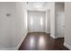 Bright entryway with hardwood floors, white walls, a storm door, and a view of the foyer at 96 Foxtail Ct, Clayton, NC 27520