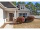 Attractive front entrance with a stylish door, manicured shrubs, and stone accents at 96 Foxtail Ct, Clayton, NC 27520