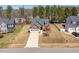 Aerial view of a well-manicured home with a long driveway, nestled among lush trees at 96 Foxtail Ct, Clayton, NC 27520
