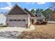 Home with a 2-car garage, brown door, and well maintained landscaping around the yard at 96 Foxtail Ct, Clayton, NC 27520