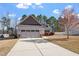 Single-Gathering home with an attached two-car garage, nicely landscaped lawn, and mature trees at 96 Foxtail Ct, Clayton, NC 27520