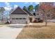 Charming single-Gathering home with attached garage, manicured lawn, and colorful shrubbery at 96 Foxtail Ct, Clayton, NC 27520