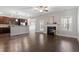 Open-concept living area featuring hardwood flooring, a fireplace, and view of the kitchen at 96 Foxtail Ct, Clayton, NC 27520
