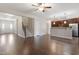 Spacious open-concept living area with hardwood floors, staircase, and view of the kitchen at 96 Foxtail Ct, Clayton, NC 27520