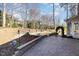 Beautiful backyard featuring a stone patio, retaining wall, and lush landscaping at 10016 Porto Fino Ave, Wake Forest, NC 27587