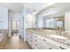 Bathroom with dual vanity, granite countertops, and a large mirror at 10016 Porto Fino Ave, Wake Forest, NC 27587