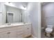 Bright bathroom features a double sink vanity and tiled shower, offering modern comfort at 10016 Porto Fino Ave, Wake Forest, NC 27587