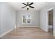 Bedroom featuring a ceiling fan, a window, and neutral walls with ensuite bathroom at 10016 Porto Fino Ave, Wake Forest, NC 27587