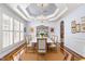 Formal dining room with designer lighting, wainscoting, and a large table for entertaining at 10016 Porto Fino Ave, Wake Forest, NC 27587