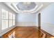 Elegant dining room with hardwood floors, wainscoting, and a modern chandelier at 10016 Porto Fino Ave, Wake Forest, NC 27587
