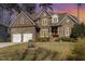 Beautiful two-story brick and stone home with a two-car garage and manicured lawn at 10016 Porto Fino Ave, Wake Forest, NC 27587