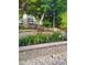 Beautiful backyard garden with colorful flowers and a charming stone retaining wall at 10016 Porto Fino Ave, Wake Forest, NC 27587
