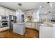 Kitchen with island, granite countertops, stainless appliances, and abundant custom cabinetry at 10016 Porto Fino Ave, Wake Forest, NC 27587