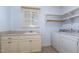 Laundry room features built-in shelving, counter space, and sink at 10016 Porto Fino Ave, Wake Forest, NC 27587