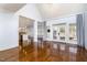 Living area with hardwood floors, French doors to a patio, and view to an eat-in kitchen at 10016 Porto Fino Ave, Wake Forest, NC 27587
