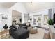Living room area with a comfortable sectional sofa, French doors, and view into the dining area at 10016 Porto Fino Ave, Wake Forest, NC 27587
