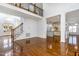 Open floor plan with high ceilings, wood floors, staircase, and view into the kitchen at 10016 Porto Fino Ave, Wake Forest, NC 27587