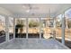 Light-filled sunroom with tiled floor and large windows with outdoor view at 10016 Porto Fino Ave, Wake Forest, NC 27587